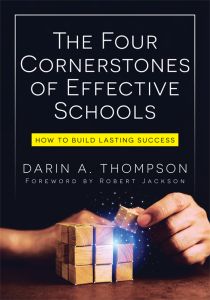 The Four Cornerstones of Effective Schools: How to Build Lasting Success by Darin A. Thompson; Foreword by Robert Jackson; A hand adds a glowing cube to a wooden block structure.